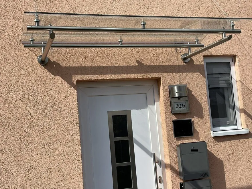 Vordach aus Edelstahl Modell Elegance mit VSG-TVG Türvordach Wetterschutz Überdachung
